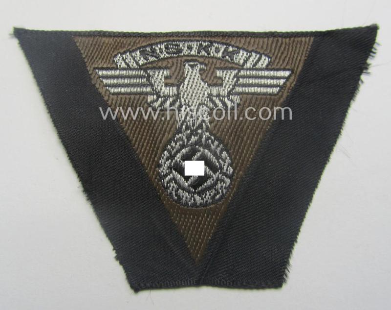Never used - ie. 'virtually mint'! - so-called: N.S.K.K. (ie. 'National Soc. Kraftfahr Korps') side-cap-eagle (ie. 'Adler für Schiffchenmütze') being a 'flat-wire-woven'-example that comes mounted onto a darker-brown-coloured background