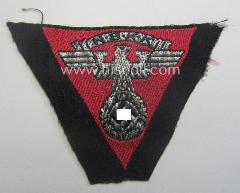 Never used - ie. 'virtually mint'! - so-called: N.S.K.K. (ie. 'National Soc. Kraftfahr Korps') side-cap-eagle (ie. 'Adler für Schiffchenmütze') being a 'flat-wire-woven'-example that comes mounted onto a pinkish-red-coloured background