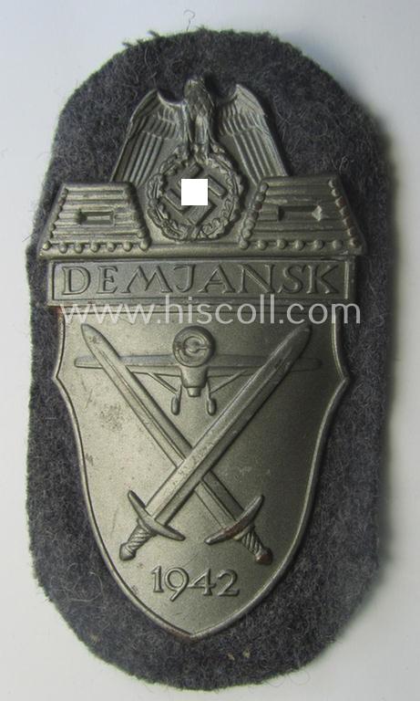 WH (Luftwaffe) 'Demjansk'-campaign-shield as executed in typical magnetic metal (ie. so-called: 'Eisenblech') and that comes in an overall nice- (ie. most certainly worn but nevertheless ie. fully untouched!), condition