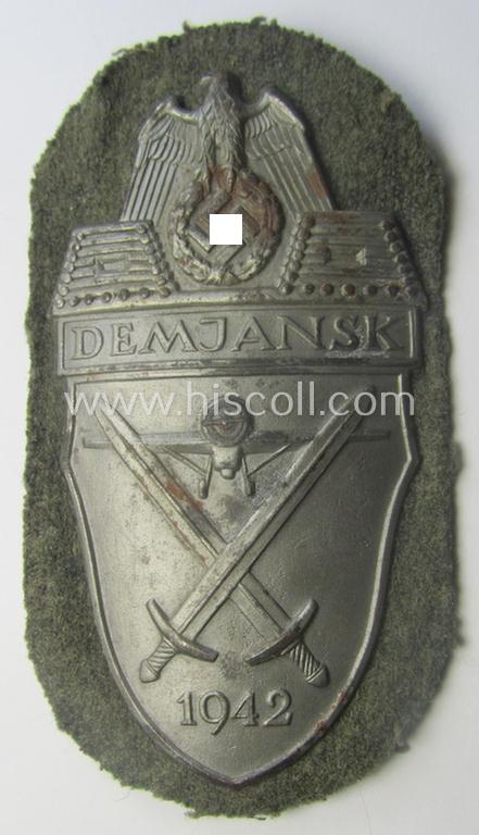WH (Heeres ie. Waffen-SS) 'Demjansk'-campaign-shield as executed in typical magnetic metal (ie. so-called: 'Eisenblech') and that comes in an overall very nice- ie. fully untouched, condition