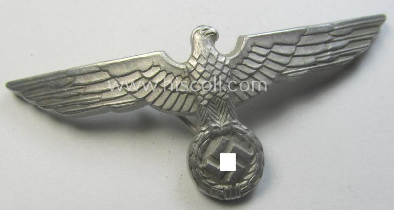 WH (Heeres) bright-silver-toned (ie. typical aluminium-based), EM- (ie. NCO- or officers') type visor-cap-eagle being a maker- (ie. 'R.H.'-) marked and/or: '1938'-dated example that comes in a moderately used- ie. once cap-attached-, condition
