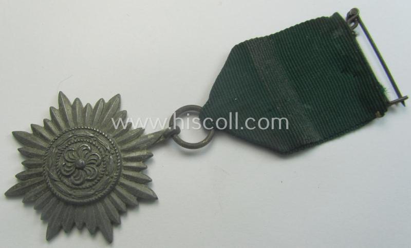 WH-related so-called: 'Verdienstauszeichnung für Angehörige der Ostvölker, 2. Klasse in Silber ohne Schwerter', being a typical non-maker-marked- and/or: 'Feinzink'-based example that comes mounted on its period ribbon