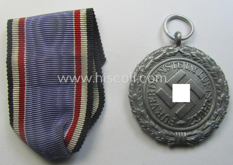 'Luftschutz-Ehrenzeichen 2. Stufe' being a maker- (ie. '10'-) marked example, as executed in (heavy) zinc-based metal (ie. 'Feinzink') and that came together with its period ribbon (ie. 'Bandabschnitt')