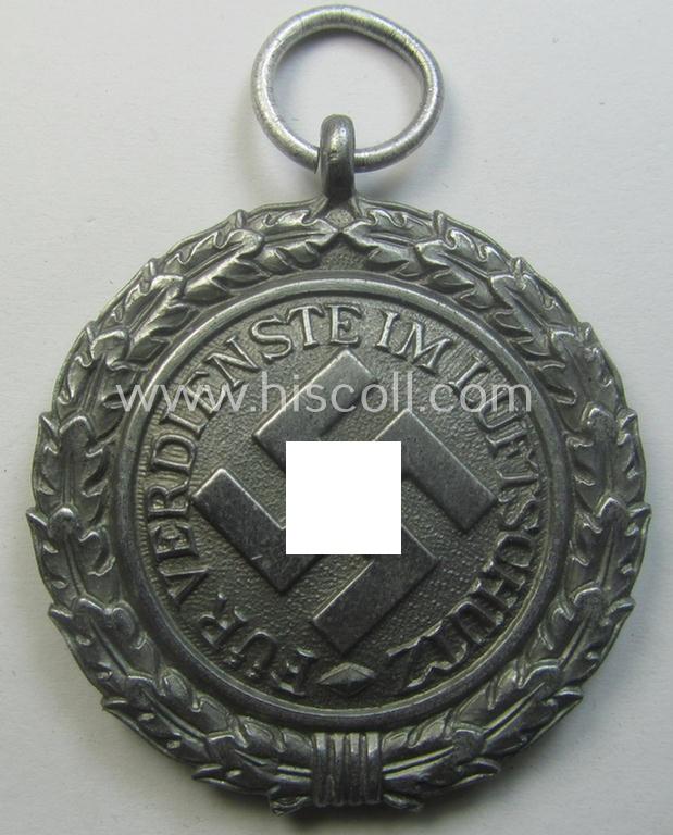 'Luftschutz-Ehrenzeichen 2. Stufe' being a maker- (ie. '10'-) marked example, as executed in (heavy) zinc-based metal (ie. 'Feinzink') and that came together with its period ribbon (ie. 'Bandabschnitt')