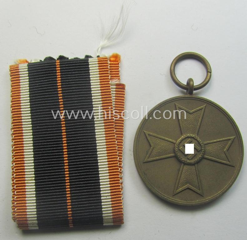 'Kriegsverdienstmedaille 1939' being a non-maker-marked- (and/or: typical 'Buntmetall'-based) specimen that came together with its full-length (and orange-red-coloured!) ribbon (ie. 'Bandabschnitt')