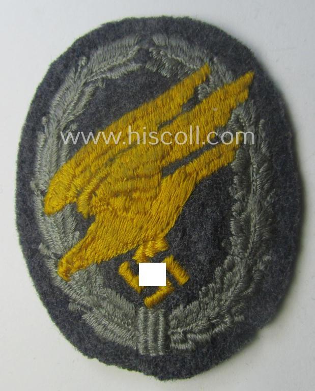 WH (Luftwaffe) 'Fallschirmschützen-Abzeichen in Stoff' (or: cloth-based paratroopers' jump-badge) that is nicely machine-embroidered and being of the so-called: 'padded version'