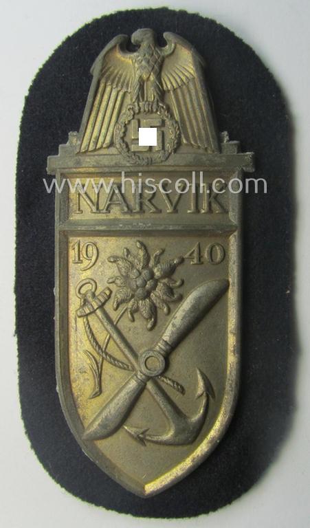 WH (Kriegsmarine) 'Narvik'-campaign-shield being a detailed example as executed in (light) golden-toned zinc- (ie. 'Feinzink') and that comes in an issued- (and/or moderately worn- ie. once tunic-attached-), condition