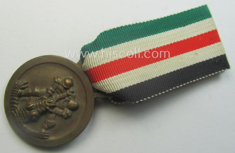 Golden-bronze-coloured (and 'Buntmetall'-based!) example of a: 'Deutsch-Italienische Feldzugsmedaille' (or: German-Italian campaign-medal) that came mounted onto its (full length- and 'virtually mint- ie. unissued') piece of original ribbon