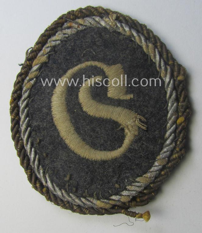 WH (Luftwaffe) machine-embroidered, trade- ie. special-career-patch (ie. 'Tätigkeitsabzeichen') having a golden-coloured 'Goldkordel' attached as was intended for: 'geprüfter Schirrmeister' (ie. senior equipment-administration staff)