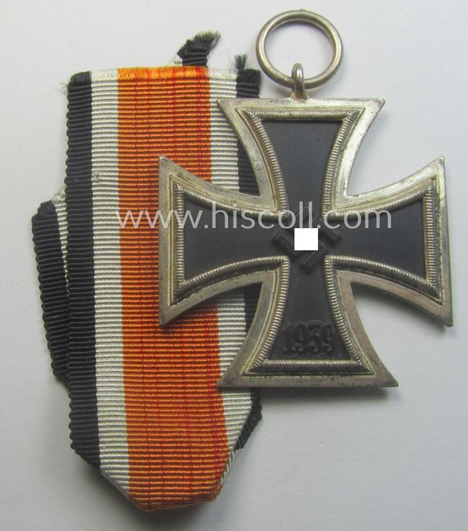 Iron Cross 2nd class (or: 'EK II. Klasse') being a non-maker-marked example that comes together with its original (shortened and orange-red-coloured) ribbon (ie. 'Bandabschnitt') as was produced by the desirable 'C.E. Juncker'-company