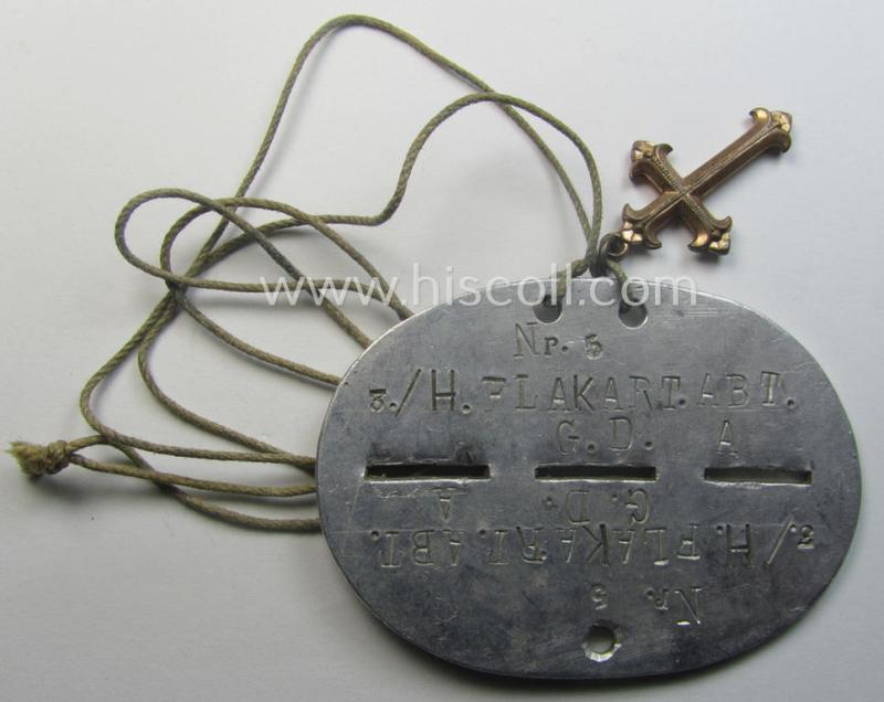 Zinc-based WH (Heeres) 'Heeres-Flak'- ie. 'GrossDeutschland-Division'-related ID-disc bearing the clearly stamped unit-designation that reads: '3./H.FlakArt.Abt. G.D.' and that comes mounted onto its period cord as worn