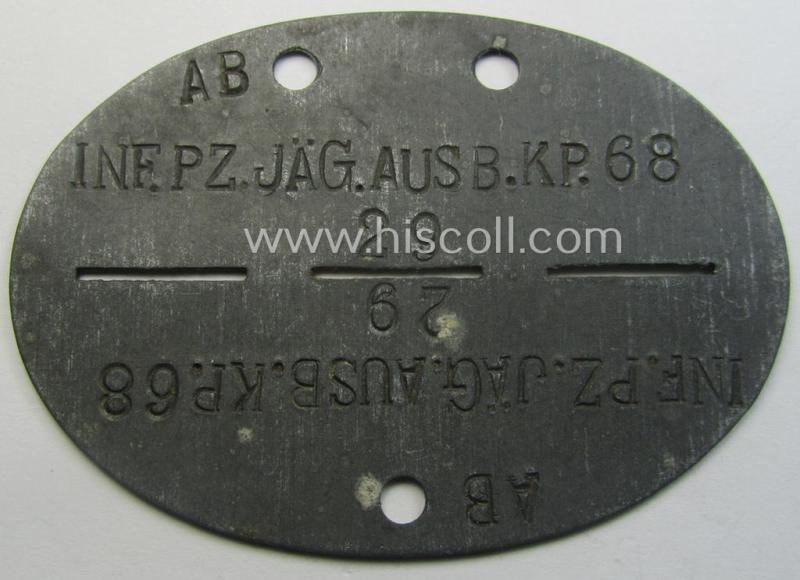 Zinc-based, WH (Heeres) 'Infanterie o. Panzerjäger'-related ID-disc bearing the clearly stamped unit-designation that reads: 'Inf.Pz.Jäg.Ausb.Kp.68' and that comes as issued and/or worn