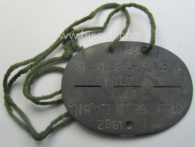 Zinc-based, WH (Heeres) 'Gebirgsjäger'-related ID-disc bearing the clearly stamped unit-designation that reads: 'Stm.Kp.Geb.Fl.E.A.Btl.Mot. 700' and that comes as issued and/or worn