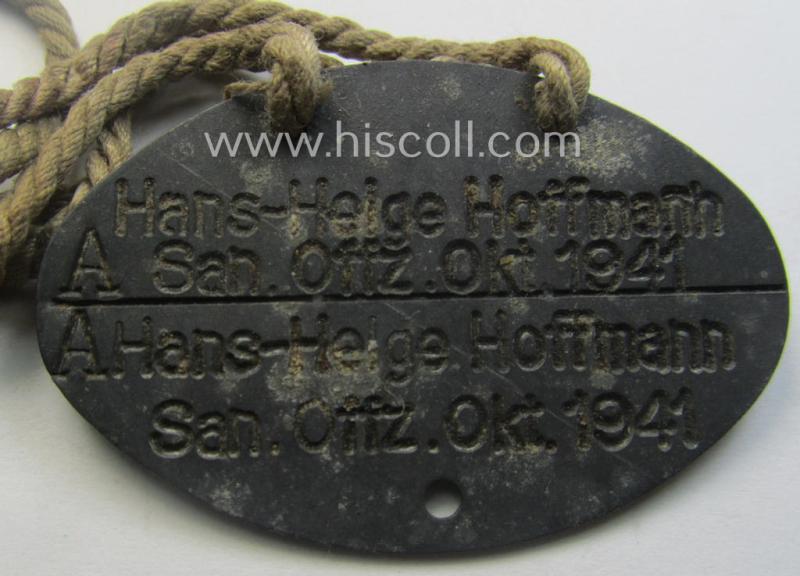 Interesting, early-war- (albeit 'standard-issue'-) pattern, WH (Kriegsmarine) typical zinc-based- and/or greyish-silver toned ID-disc (ie. 'Erkennungsmarke') bearing the engraved text that simply reads: 'Hans-Helge Hoffmann - San.Offz. Okt. 1941'