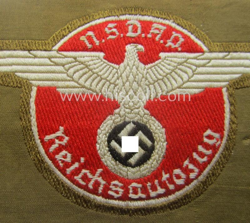Rarely encountered - and 'virtually mint- ie. unissued' - breast-badge as executed in 'BeVo-weave' pattern as was intended for members within the 'N.S.D.A.P. Reichsautozug' (or: 'RaZ') still retaining its period, paper-based 'RzM'-etiket