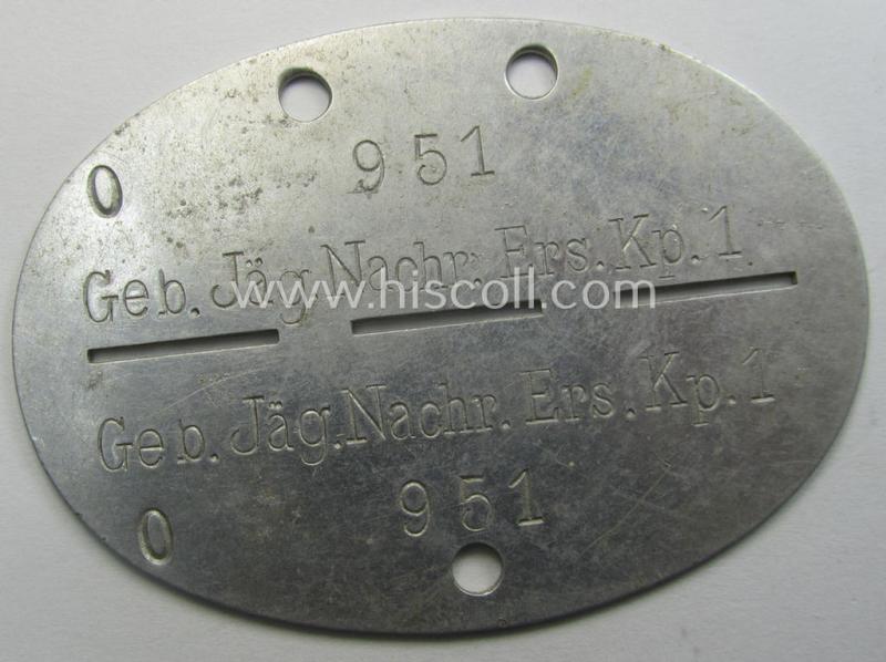Aluminium-based, WH (Heeres-) ie. 'Gebirgsjäger o. Nachrichten'-related ID-disc (ie. 'Erkennungsmarke') bearing the clearly stamped unit-designation that reads: 'Geb.Jäg.Nachr.Ers.Kp.1' and that comes as issued and found