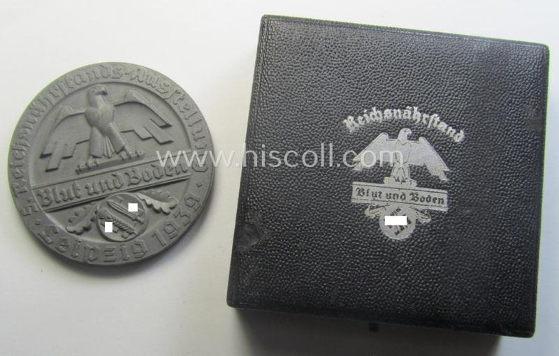 Greyish-silver-toned, 'Reichsnährstand'- (ie. 'RNSt.'-) related, commemorative-award-plaque entitled: 'Reichsnährstands-Austellung - Blut und Boden - Leipzig 1939 - erhitzte Milch' and that comes stored in its period etui
