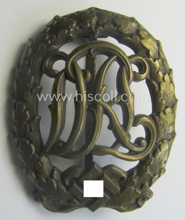 'Reichssportabzeichen DRL in Bronze' (or: bronze class DRL sports'-badge) being a just moderately worn- ie. used example that is nicely maker- (ie. 'Wernstein - Jena'-) marked on its back