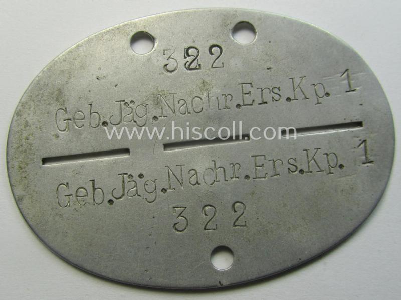 Aluminium-based, WH (Heeres-) ie. 'Gebirgsjäger o. Nachrichten'-related ID-disc (ie. 'Erkennungsmarke') bearing the clearly stamped unit-designation that reads: 'Geb.Jäg.Nachr.Ers.Kp.1' and that comes as issued and found