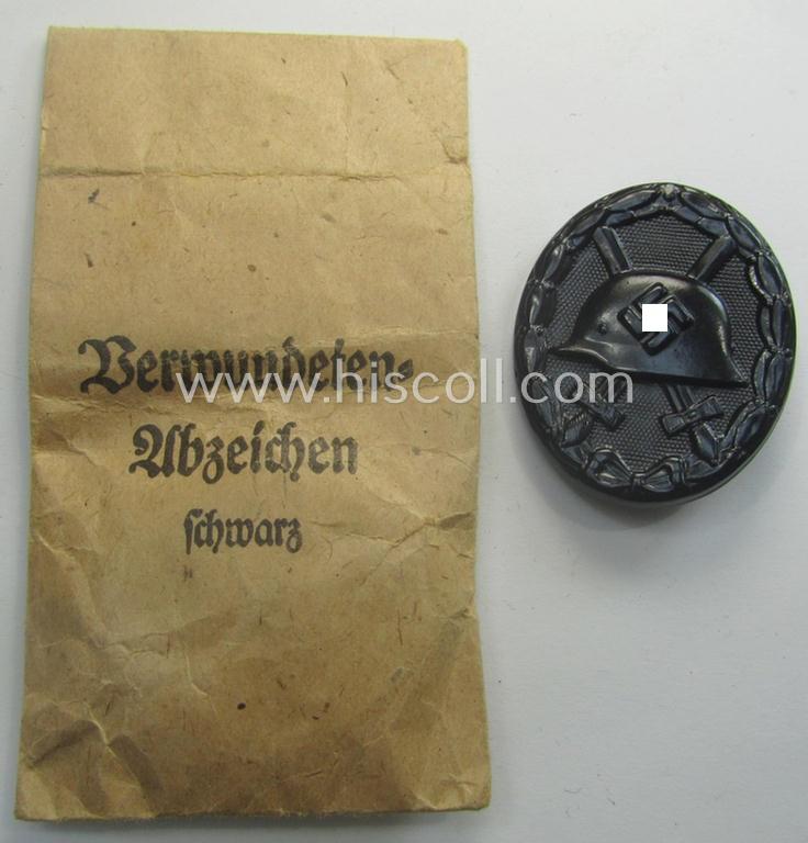 'Verwundeten-Abzeichen in Schwarz' being a maker- (ie. 'L/16'-) marked example by the: 'Steinhauer & Lück'-company that came stored in its (scarcely seen!) period pouch