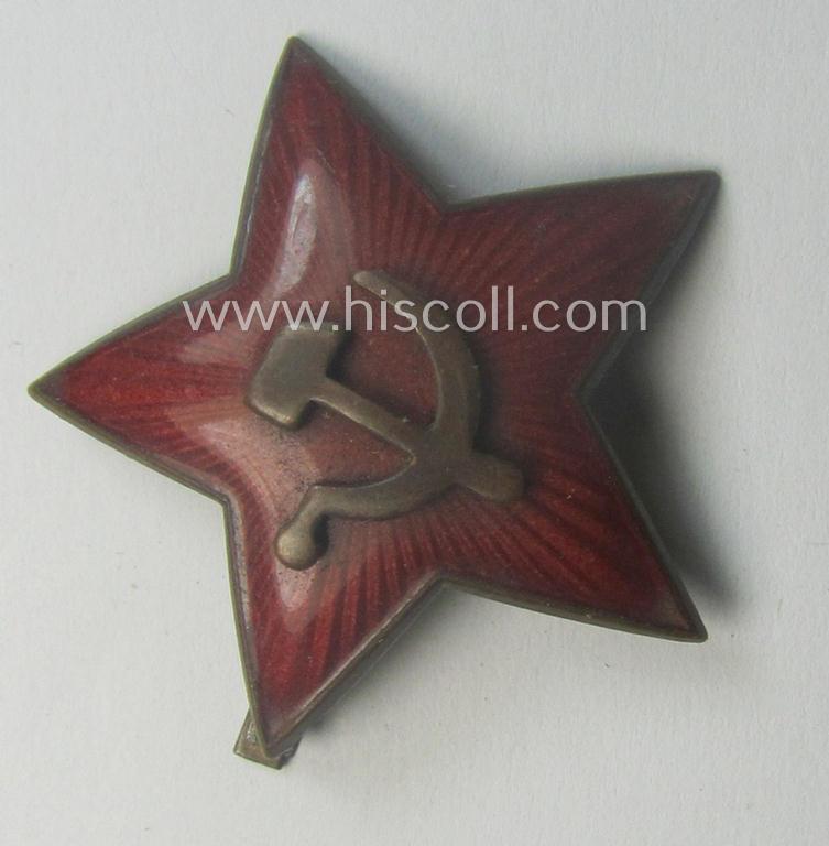 Unusal item that originated from a German soldier: a Russian, larger-sized and/or WWII-period, enamelled star-shaped cap-badge showing the communist logo on a bright-red-coloured surface