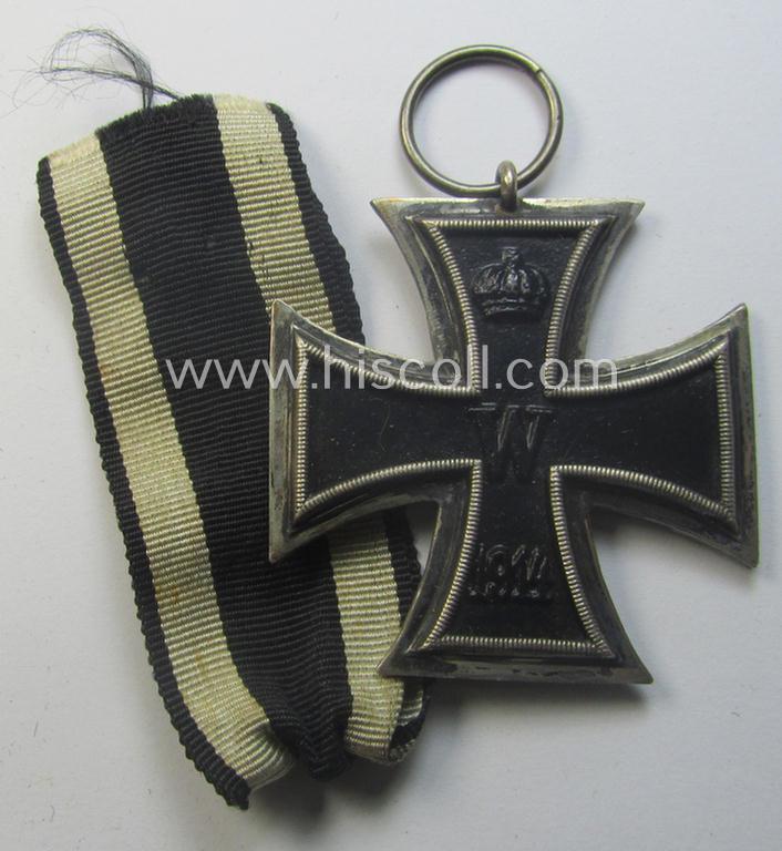 WWI-period: 'Eisernes Kreuz II. Klasse' (or: iron cross second class) being a (typical) non-maker-marked example that comes together with its (minimally) confectioned piece of ribbon (ie. 'Bandabschnitt')