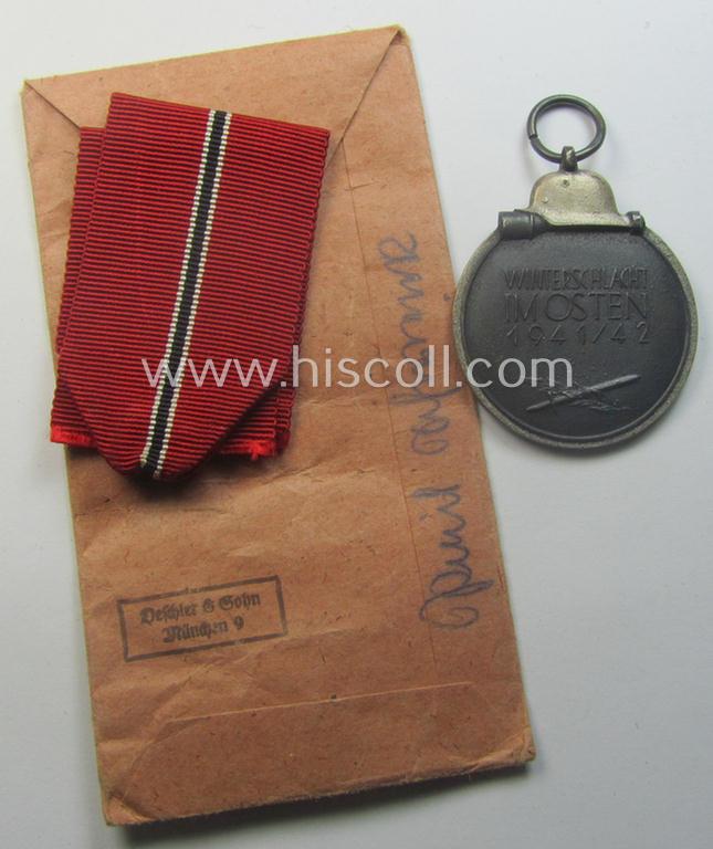 Medal-set: 'Winterschlacht im Osten 1941/42' as produced by the: 'Deschler u. Sohn'-company being a clearly maker- ie. '1'-marked specimen that came stored in its original 'Zellstoff'-based pouch of issue as found