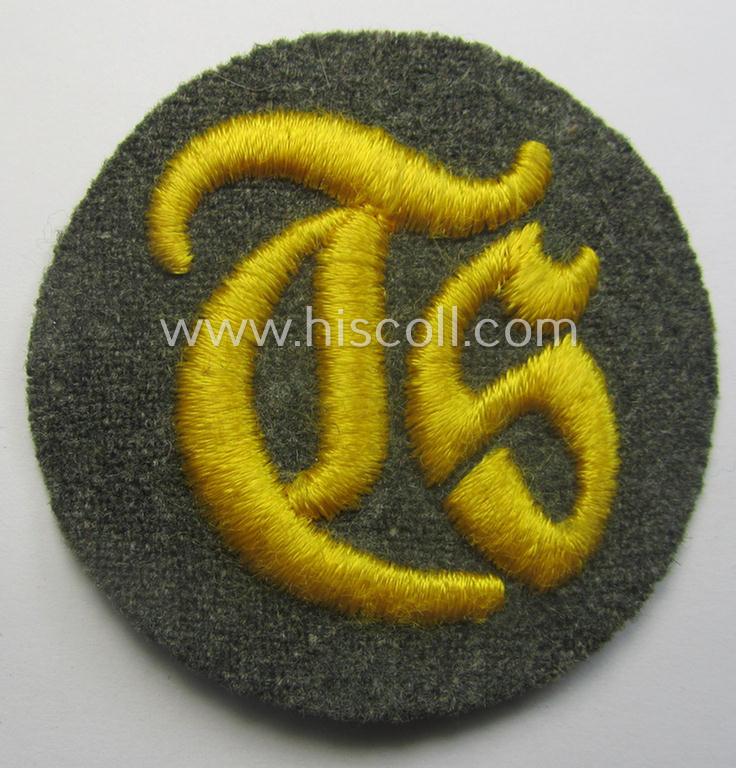 WH (Heeres) machine-embroidered, trade- and/or special-career insignia (ie. 'Tätigkeitsabzeichen') as executed on a field-grey-coloured background as was specifically intended for a: 'Truppensattlermeister'