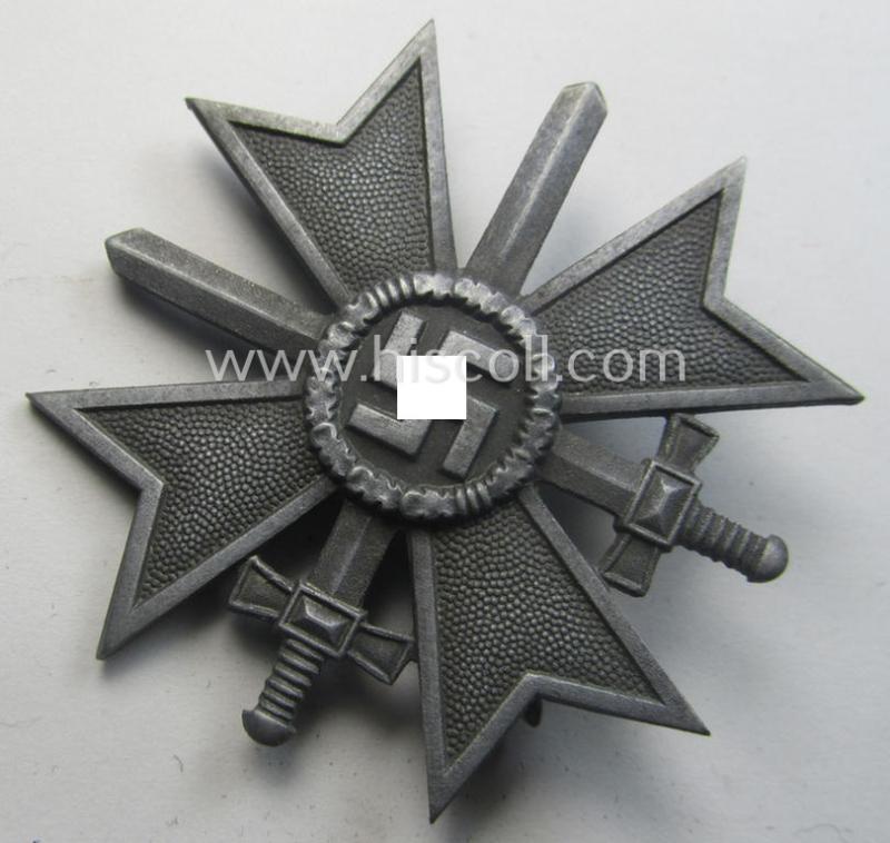 'Kriegsverdienstkreuz 1. Klasse mit Schwertern' being a non-maker-marked specimen by a (by me) unidentified maker as executed in silverish-grey-coloured and/or typical zinc-based metal (ie. 'Feinzink')
