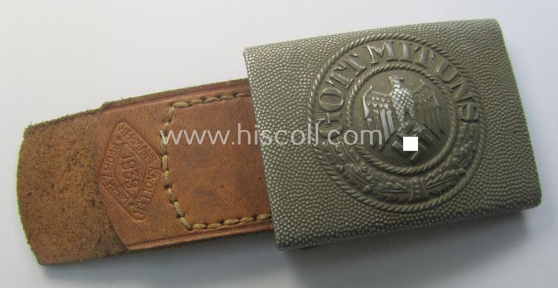 WH (Heeres) 'standard-pattern', field-grey-toned- and aluminium-based belt-buckle being a maker- (ie. 'Hermann Knoller - Pforzheim'-) marked- and/or: '1939'-dated example that comes mounted onto its leather-based tab
