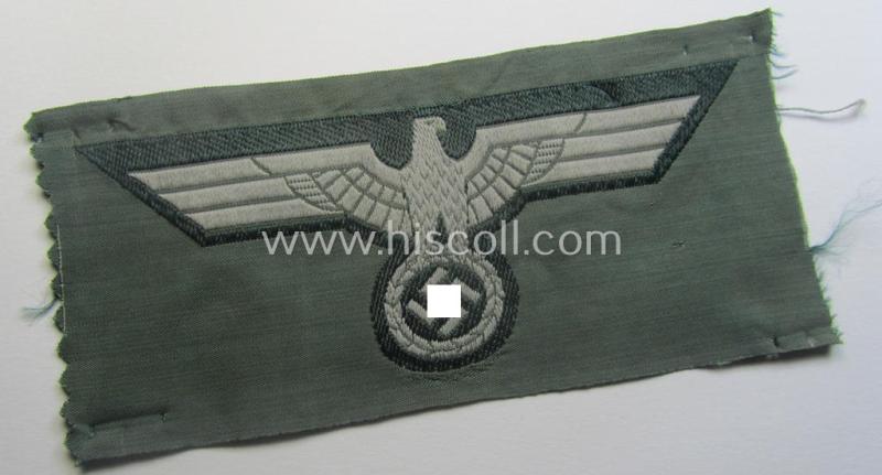 WH (Heeres) early-war-period- and/or greyish-coloured breast-eagle of the: 'M40'-pattern as was executed in the 'BeVo'-weave pattern on a darker-green-coloured background