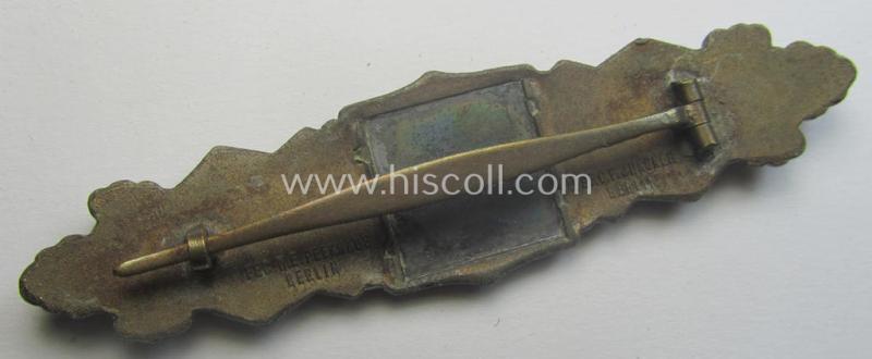 'Nahkampfspange in Bronze' (or: bronze-class close-combat clasp ie. CCC) being a neatly maker-marked- and/or minimally converse-shaped specimen by the maker- (ie. 'Hersteller') 'C.E. Juncker - Berlin'