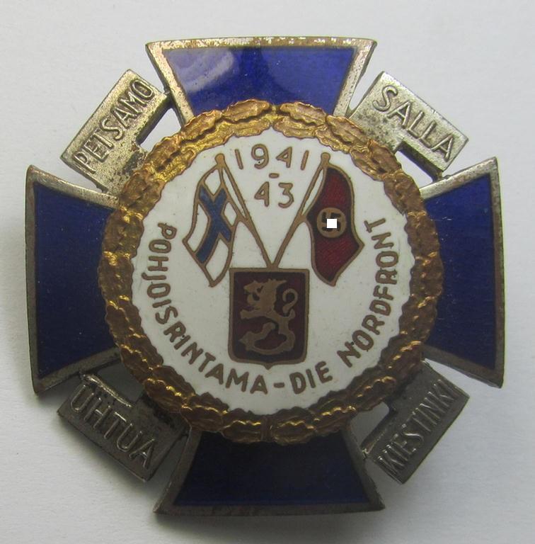 Finnish-/German: 'Nordfrontkreuz', being a white-/blue-coloured and maker- (ie. 'Hopeatakomo o.y.'-) marked 'variant' that shows the text: 'Pohjoisrintama - Die Nordfront - 1941/43'