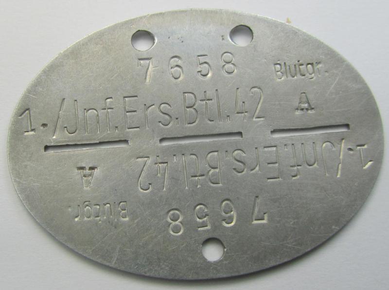 Aluminium-based, WH (Heeres) ie. 'Infanterie'-related ID-disc that shows the stamped unit-designation: '1./Inf.Ers.Btl. 42'