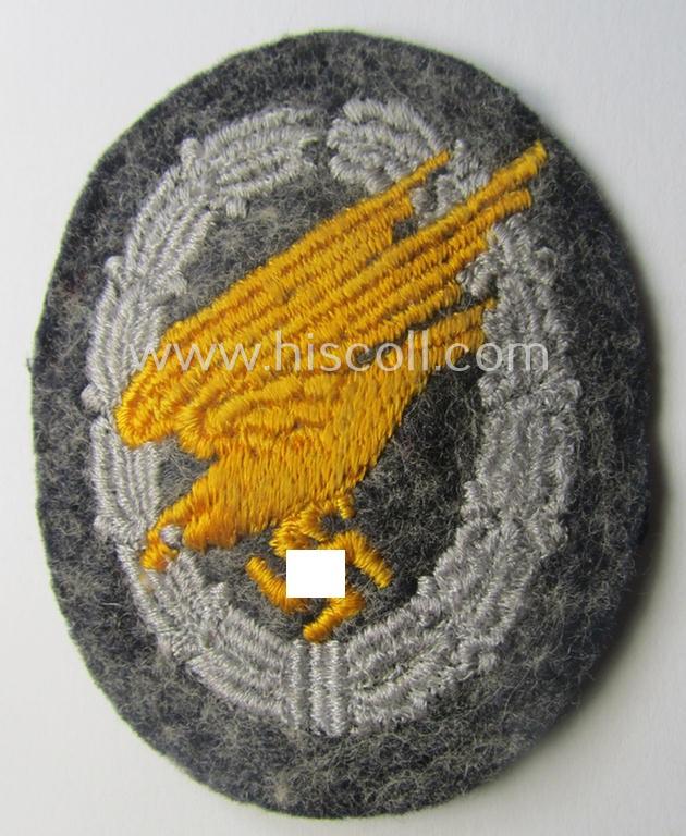 WH (Luftwaffe) 'Fallschirmschützen-Abzeichen in Stoff' (or: cloth-based paratroopers' jump-badge) that is nicely machine-embroidered and being of the so-called: 'padded version'