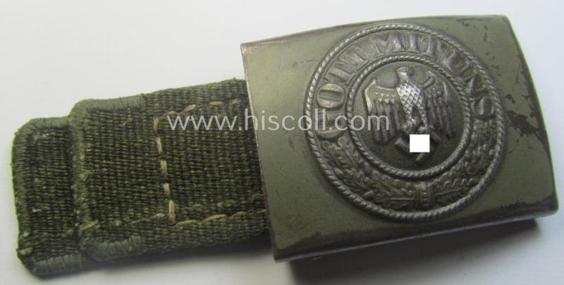 WH (Heeres) 'tropical-issued' belt-buckle being a clearly maker- (ie. 'IKA 41'-) marked, field-grey-coloured example that comes mounted onto its original, greenish-coloured- (and/or: 'webbing'-based-) tab