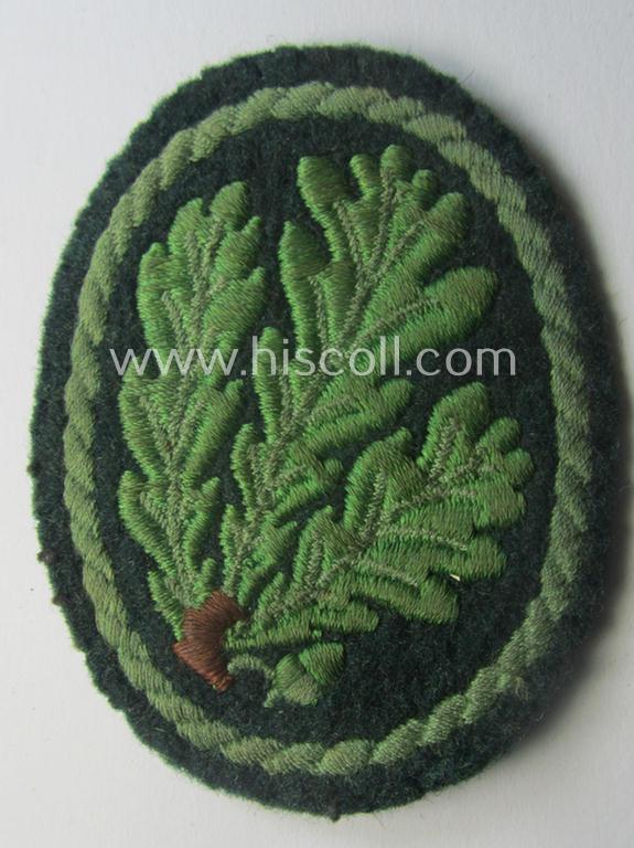 Truly used WH (Heeres) so-called: 'Jäger'-armbadge being a neatly machine-embroidered- and/or multi-coloured version as was executed on darker-green-coloured 'felt-based'-wool