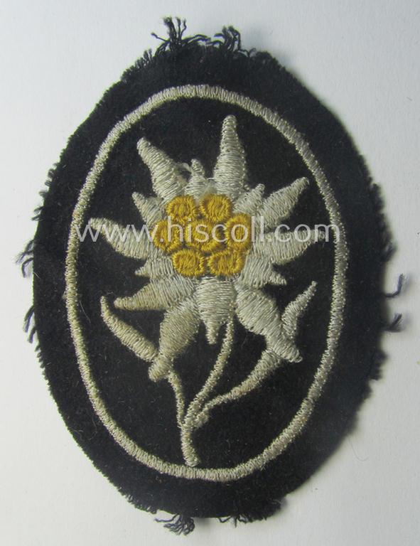 Waffen-SS-pattern, black-coloured sleeve-insignia (ie. 'Ärmelabzeichen') depicting an: 'Edelweiss'-flower as used by the various 'Gebirgsjäger'- (ie. mountain-troops-) related divisional-staff