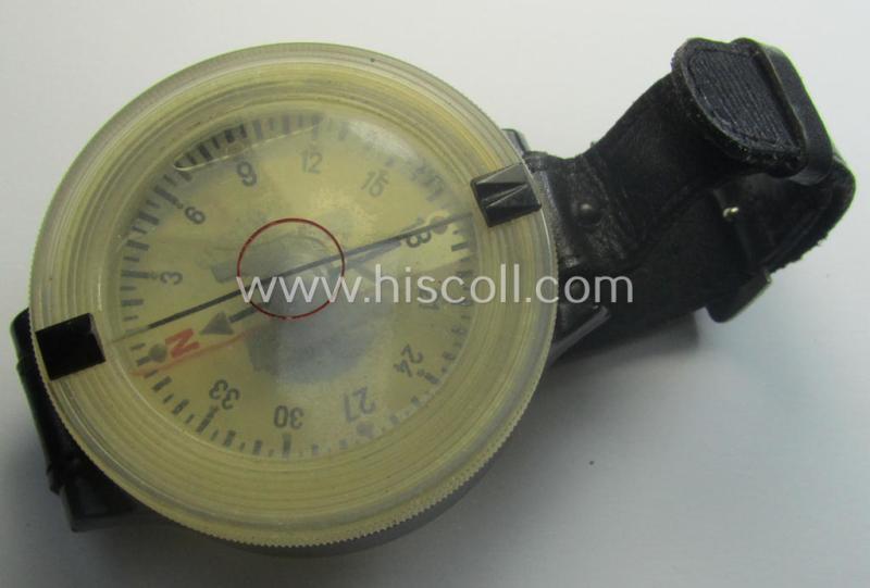 Attractive - and/or fully functional! - example of a WH (Luftwaffe) black-coloured- and/or resin-based, pilots'-armband-compass of the type: 'AK 39' that comes mounted onto its period, bluish-black-coloured strap as issued and/or used