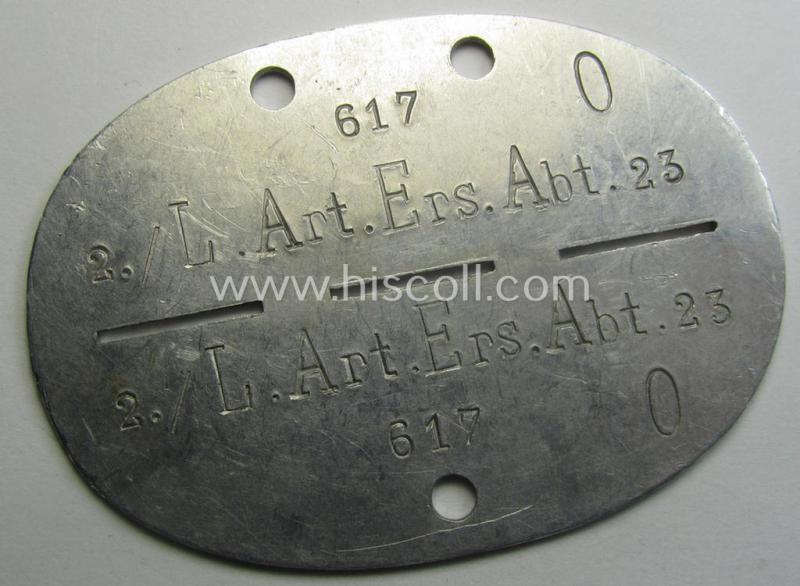 Aluminium-based, WH (Heeres) 'Artillerie'- (ie. artillery-) related ID-disc bearing the clearly stamped unit-designation that simply reads: '2./L.Art.Ers.Abt. 23' and that comes as issued- and/or worn