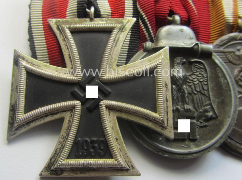 4-pieced, WWII-period medal-bar (ie. 'Ordenspange') showing resp. an: 'EKII.Kl.', a: 'Medaille Winterschlacht im Osten 1941-42' a: 'KvKII.Kl. m. Schw.', a: 'Westwall'-medal and 'Kriegsverdienstmed. 1939'