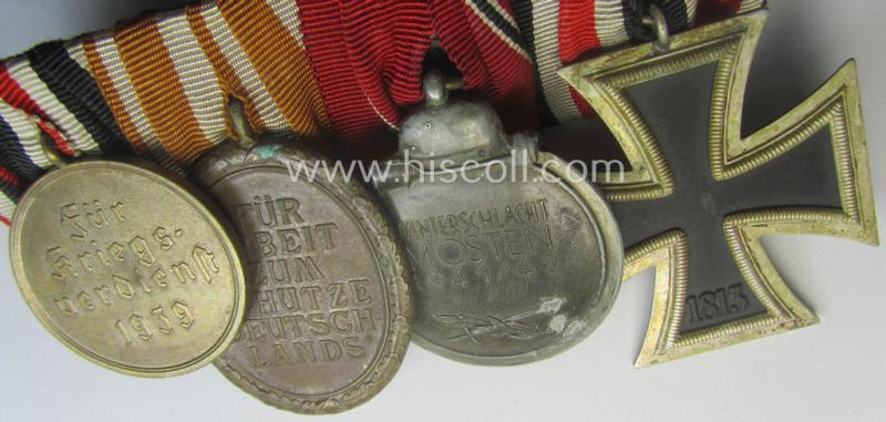 4-pieced, WWII-period medal-bar (ie. 'Ordenspange') showing resp. an: 'EKII.Kl.', a: 'Medaille Winterschlacht im Osten 1941-42' a: 'KvKII.Kl. m. Schw.', a: 'Westwall'-medal and 'Kriegsverdienstmed. 1939'