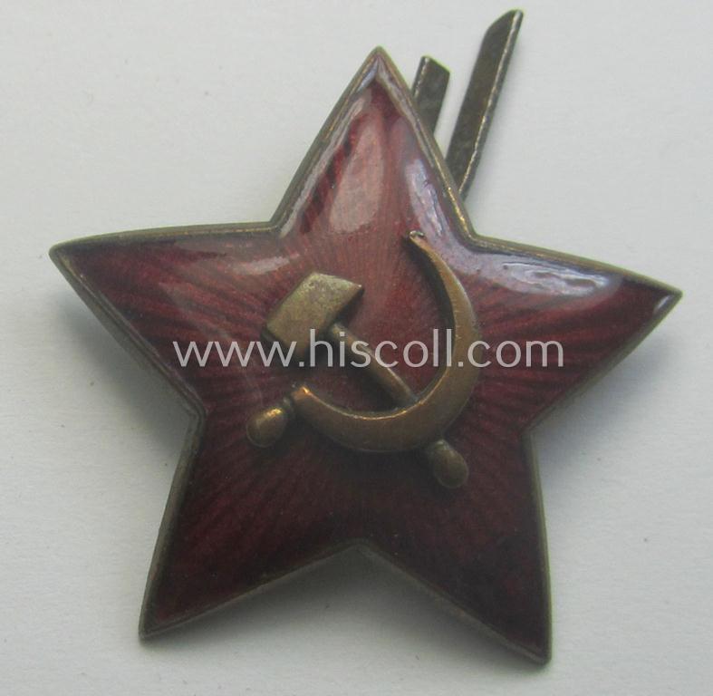 Unusal item that originated from a German soldier: a Russian, larger-sized and/or WWII-period, enamelled star-shaped cap-badge showing the communist logo on a bright-red-coloured surface