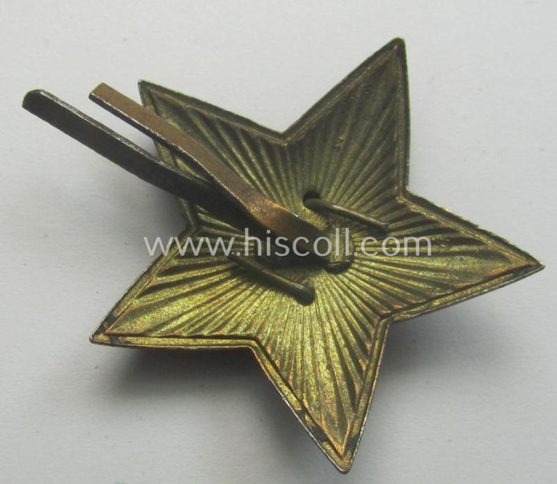 Unusal item that originated from a German soldier: a Russian, larger-sized and/or WWII-period, enamelled star-shaped cap-badge showing the communist logo on a bright-red-coloured surface