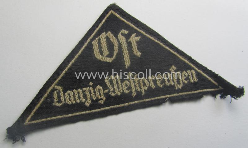 Extremely rarely encountered, 'HJ' ('Hitlerjugend') ie. 'BDM'- ('Bund Deutscher Mädel') district-triangle (ie. 'Gebietsdreieck') entitled: 'Ost Danzig-Westpreussen' being a truly worn- ie. used specimen that misses its 'RzM'-etiket