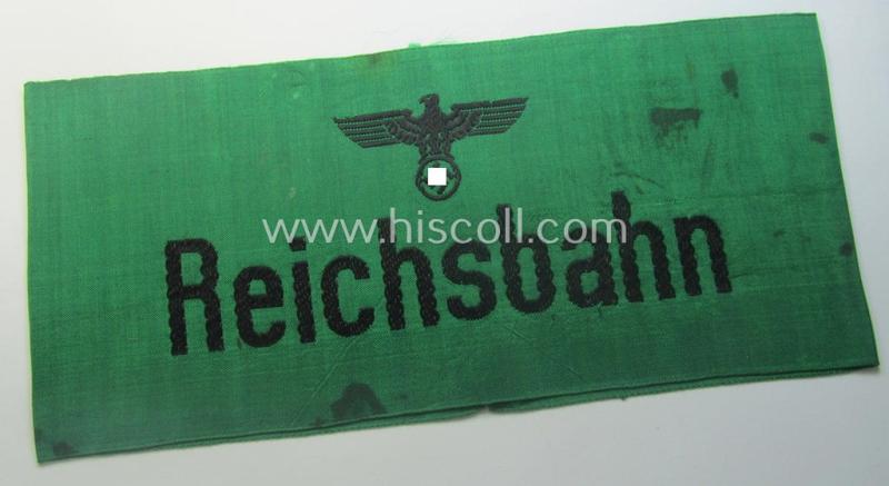 DRB- (ie. 'Deutsche Reichsbahn'-) related armband entitled: 'Reichsbahn' being of the 'entirely-woven'-type onto (typical) silk-like cloth in a technique similar to the 'BeVo'-weave pattern