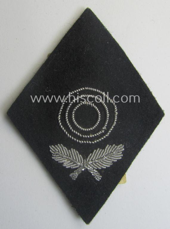 'SS'-related sleeve-diamond (ie.: 'Ärmelraute o. Schiessauszeichnung der 1. Stufe für Scharfschützen') being a very detailed- and hand-embroidered example that still retains its period, paper-based: 'RzM-Etiket'