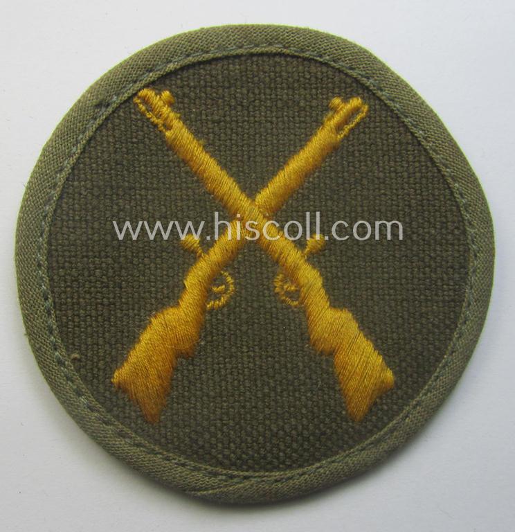WH (Heeres) 'tropical'-issued, trade- and/or special-career insignia (ie. machine-embroidered 'Laufbahn- o. Tätigkeitsabzeichen') as was intended for an army: 'Waffenmeister' (or: weapon-equipment NCO)