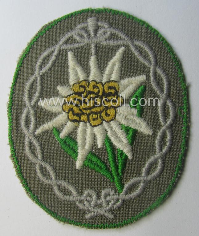 'Variant'-pattern WH (Heeres) 'Gebirgsjäger'- (ie. mountain-troopers-) related arm-badge, being a desirable example as was executed in the machine-woven pattern on thin-shaped (and bright-green rimmed) background