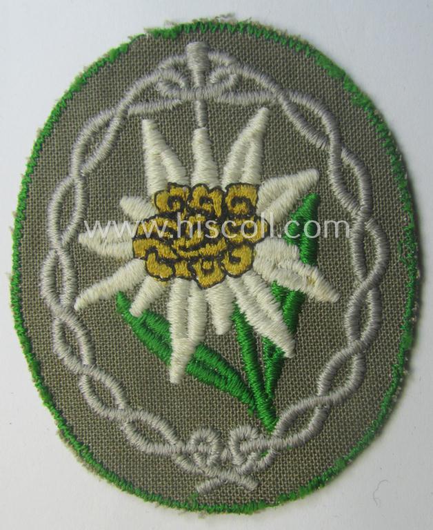 'Variant'-pattern WH (Heeres) 'Gebirgsjäger'- (ie. mountain-troopers-) related arm-badge, being a desirable example as was executed in the machine-woven pattern on thin-shaped (and bright-green rimmed) background